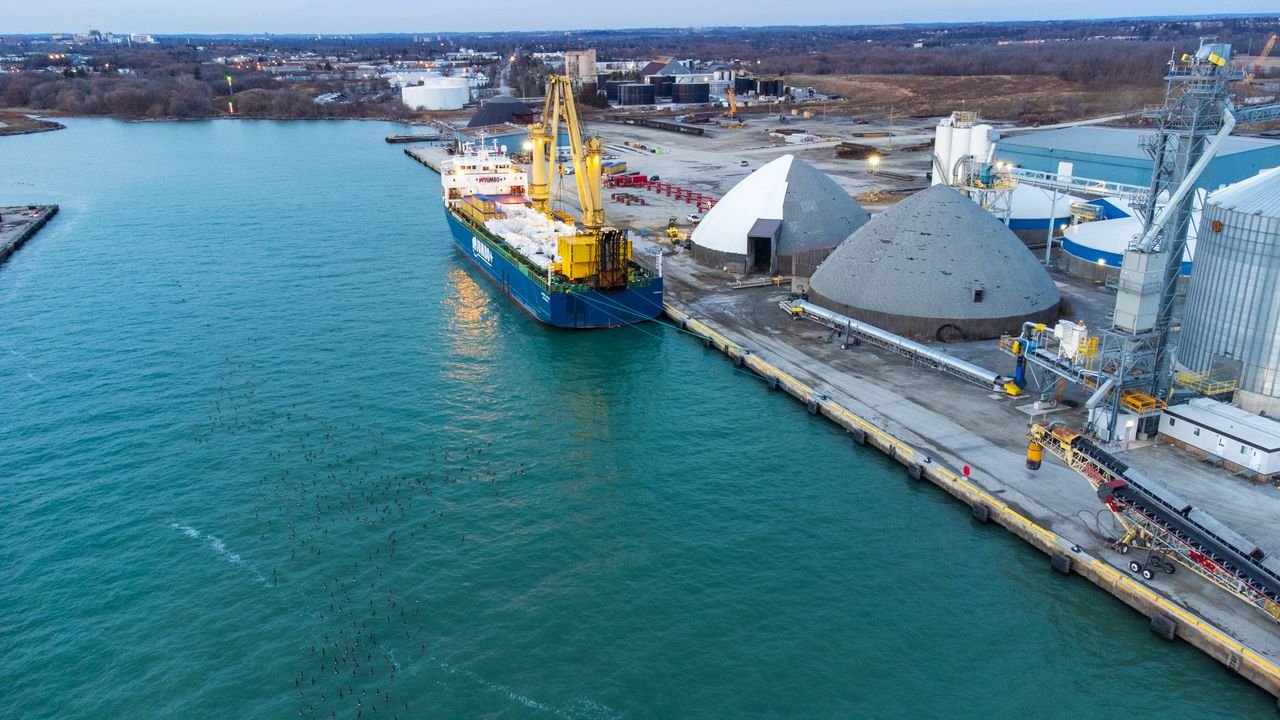 our-story Aerial view of a cargo ship docked at the industrial Port of Oshawa, Canada.