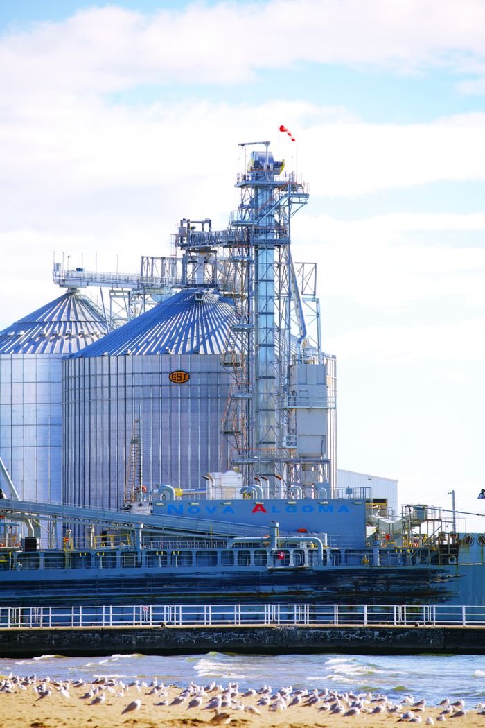 Industrial silos and seagulls by the waterfront in Oshawa, Ontario, Canada.